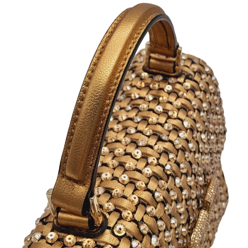 298 - A Valentino Gold Mini VSLING Bag. Woven leather and stone embellished exterior with gold-toned hardw... 