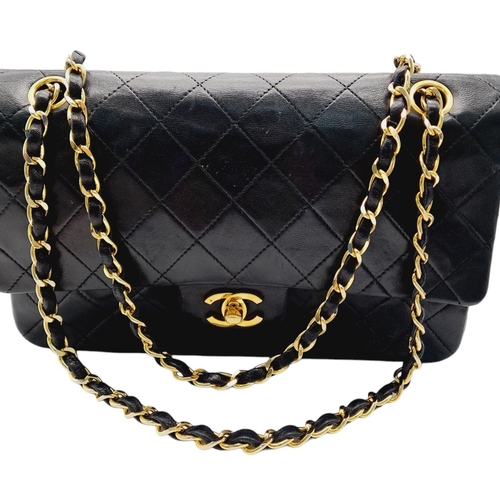 305 - A Chanel Black Classic Double Flap Bag. Leather exterior with gold-toned hardware, chain and leather... 