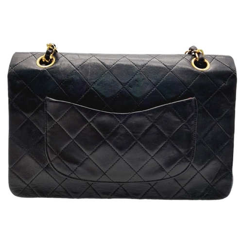 305 - A Chanel Black Classic Double Flap Bag. Leather exterior with gold-toned hardware, chain and leather... 