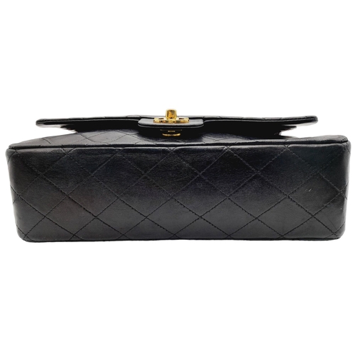 305 - A Chanel Black Classic Double Flap Bag. Leather exterior with gold-toned hardware, chain and leather... 