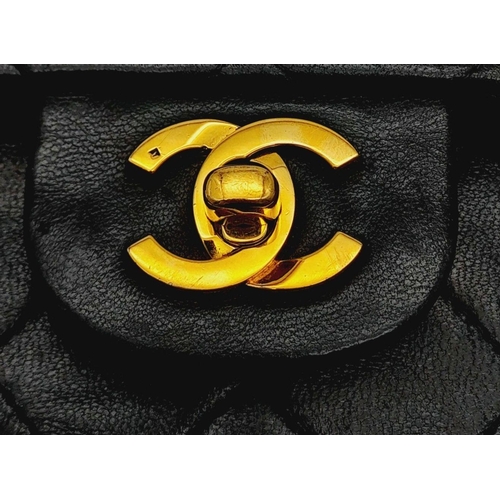 305 - A Chanel Black Classic Double Flap Bag. Leather exterior with gold-toned hardware, chain and leather... 