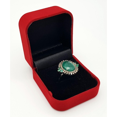 183 - A 7.70ct Emerald Ring with 0.85ctw of Diamond Surround and 0.27ct Emerald Accents. Size O. Comes wit... 