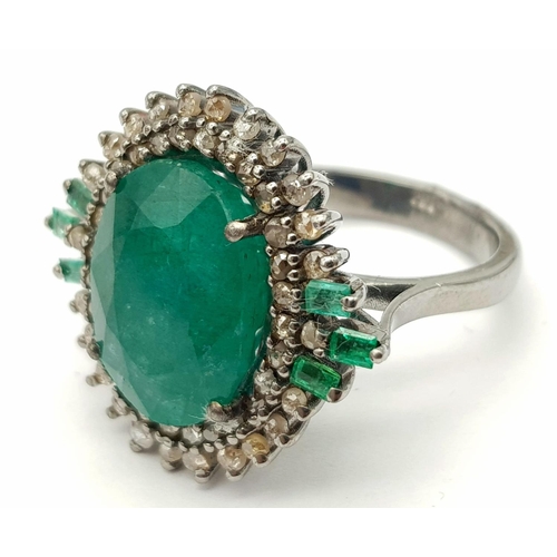 183 - A 7.70ct Emerald Ring with 0.85ctw of Diamond Surround and 0.27ct Emerald Accents. Size O. Comes wit... 