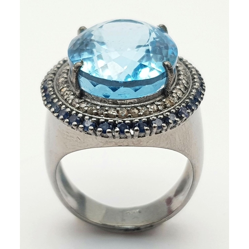 24 - A Mesmerising 10ct Blue Topaz Gemstone Ring with a 0.65ctw Diamond Surround set in 925 Silver. Size ... 