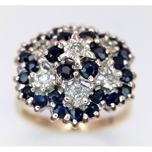 278 - A 9K YELLOW GOLD, DIAMOND & SAPPHIRE FLORAL FORM RING - 5.3G. SIZE Q. REF: SC4001