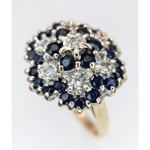 278 - A 9K YELLOW GOLD, DIAMOND & SAPPHIRE FLORAL FORM RING - 5.3G. SIZE Q. REF: SC4001