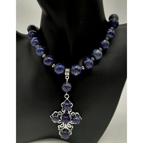 1051 - A sterling silver and genuine lapis lazuli necklace and earrings set with large cross shaped pendant... 