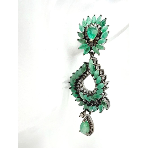 1038 - An vintage sterling silver pair of earrings with old cut diamonds and oval cut emeralds. In excellen... 