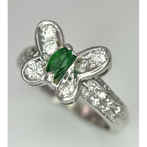 186 - A 18K WHITE GOLD DIAMOND & EMERALD BUTTERFLY RING. 4.7G IN WEIGHT. SIZE K. Ref: 8458.