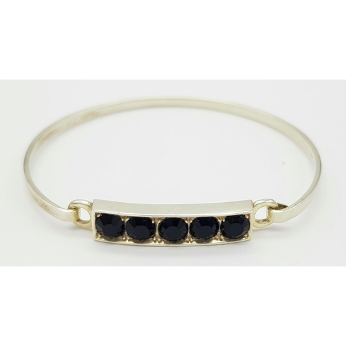 245 - Genuine Paul Kennedy SILVER and BLACK ONYX BANGLE. Having five cushion cut BLACK ONYX mounted to top... 