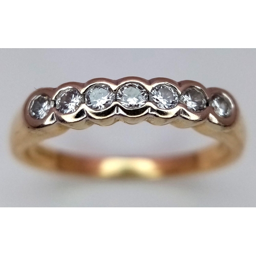 250 - A 18K YELLOW GOLD 7 STONE DIAMOND RING. 0.20CT. 2.6G IN WEIGHT. SIZE I AND 1/2. Ref: SC 5037