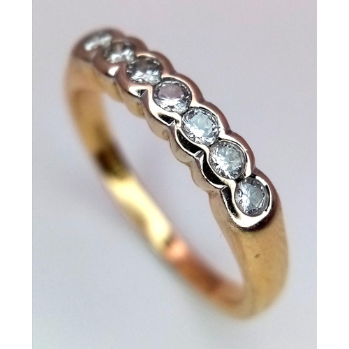 250 - A 18K YELLOW GOLD 7 STONE DIAMOND RING. 0.20CT. 2.6G IN WEIGHT. SIZE I AND 1/2. Ref: SC 5037