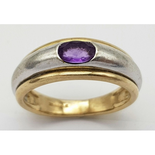 266 - Impressive and unusual 9 carat YELLOW and WHITE GOLD RING, Having an oval AMETHYSYT channel set to t... 