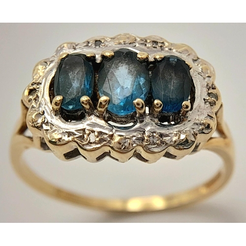 278 - A 9K YELLOW GOLD DIAMOND & TEAL SAPPHIRE RING. 2.9G IN WEIGHT. SIZE R. Ref: SC 5003.