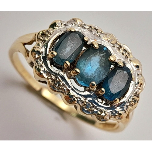 278 - A 9K YELLOW GOLD DIAMOND & TEAL SAPPHIRE RING. 2.9G IN WEIGHT. SIZE R. Ref: SC 5003.