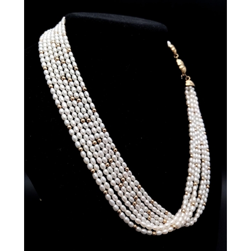 362 - A 9K YELLOW GOLD CLASPED FRESHWATER PEARL MULTI STRAND NECKLACE - WITH 9K YELLOW GOLD BALLS SET AMOM... 