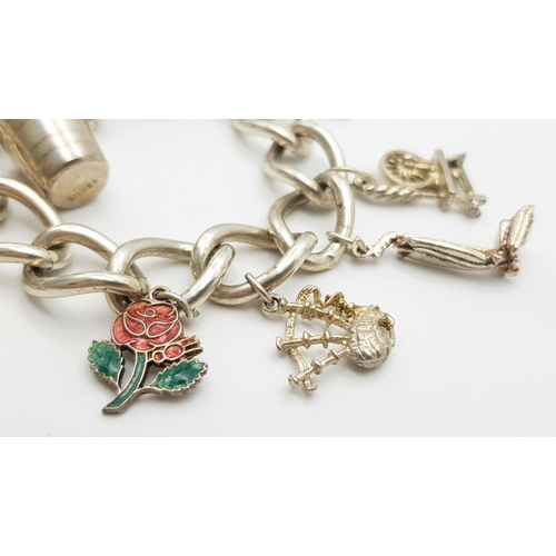 378 - Vintage SILVER CHARM BRACELET complete with safety chain. Charm to include spinning wheel ,bagpipes ... 