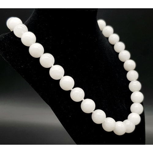 390 - A Chinese Large White Jade Bead Necklace. 14mm beads. 46cm necklace length.