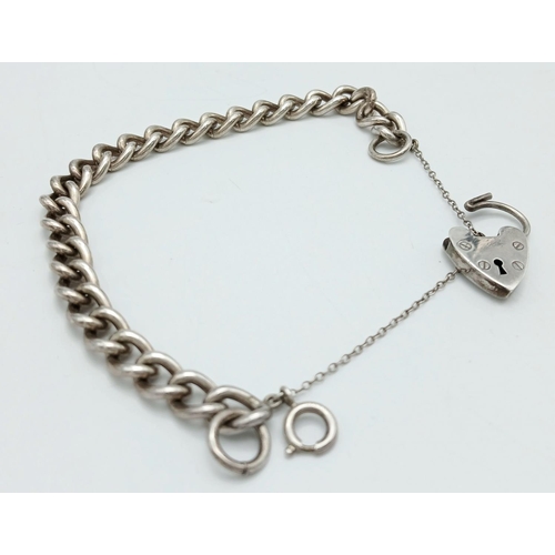 392 - Classic SILVER CHAIN LINK BRACELET. Complete with safety chain and heart padlock fastening. Fully ha... 