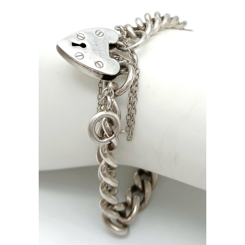 392 - Classic SILVER CHAIN LINK BRACELET. Complete with safety chain and heart padlock fastening. Fully ha... 