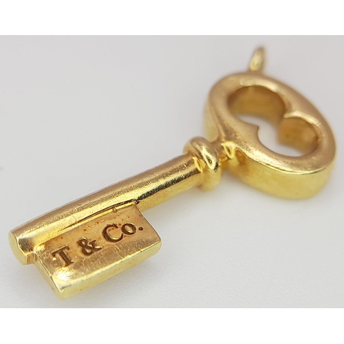 481 - A 18K YELLOW GOLD TIFFANY & CO KEY CHAR.M 1.74G IN WEIGHT. 1.6CM IN LENGTH. Ref: SC 5044.