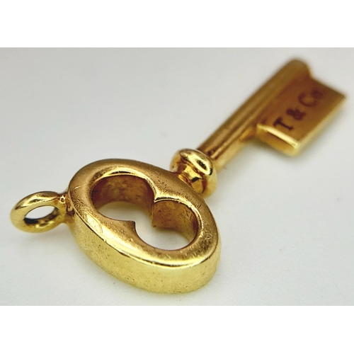 481 - A 18K YELLOW GOLD TIFFANY & CO KEY CHAR.M 1.74G IN WEIGHT. 1.6CM IN LENGTH. Ref: SC 5044.