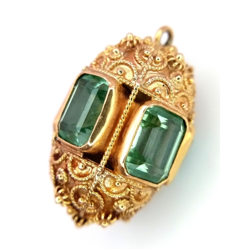 53 - An 18K Yellow Ornate Emerald Egg-Shaped Pendant. Five rectangular cut emeralds. Tests as 18k gold. 3... 