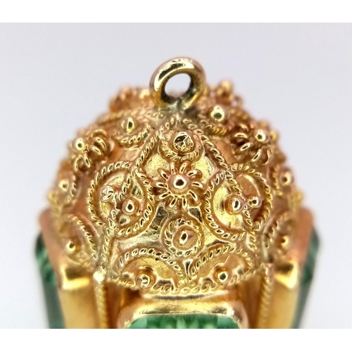 53 - An 18K Yellow Ornate Emerald Egg-Shaped Pendant. Five rectangular cut emeralds. Tests as 18k gold. 3... 