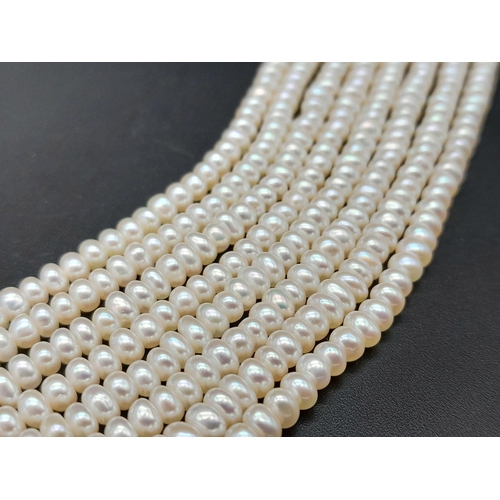 555 - An Eight Row Small Rondelle Pearl Necklace with a 9K Yellow Gold Shell Form Clasp. 42cm.