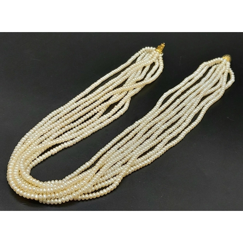 555 - An Eight Row Small Rondelle Pearl Necklace with a 9K Yellow Gold Shell Form Clasp. 42cm.