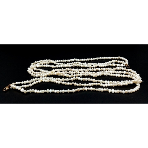 856 - A Three Row Petit Rice Pearl Necklace with 9k Gold Clasp. 40cm.