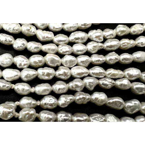 883 - A Five Row Rice Pearl Necklace with 9K Gold Clasp. 40cm.