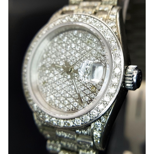 111 - A spectacular ladies ROLEX DATEJUST watch with 18 K white gold case and bracelet covered with pave r... 