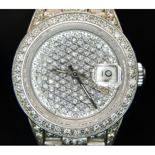 111 - A spectacular ladies ROLEX DATEJUST watch with 18 K white gold case and bracelet covered with pave r... 