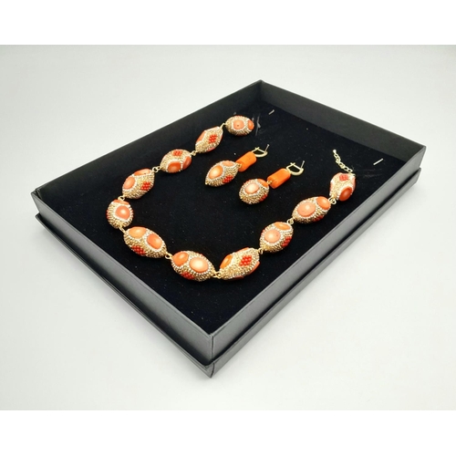 146 - A very fashionable red coral necklace and earrings set in a presentation box. Necklace length: 46-50... 