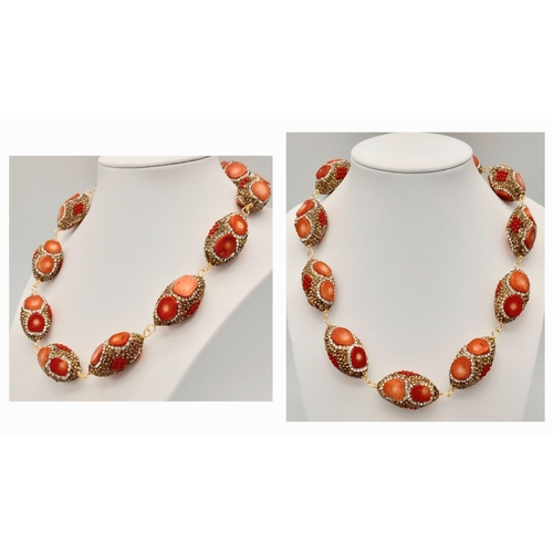 146 - A very fashionable red coral necklace and earrings set in a presentation box. Necklace length: 46-50... 