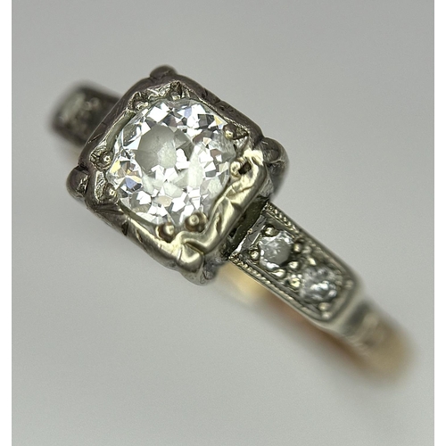 568 - A Vintage 18K Yellow Gold and Platinum Diamond Ring. 0.75ct central diamond with diamond accents. Si... 