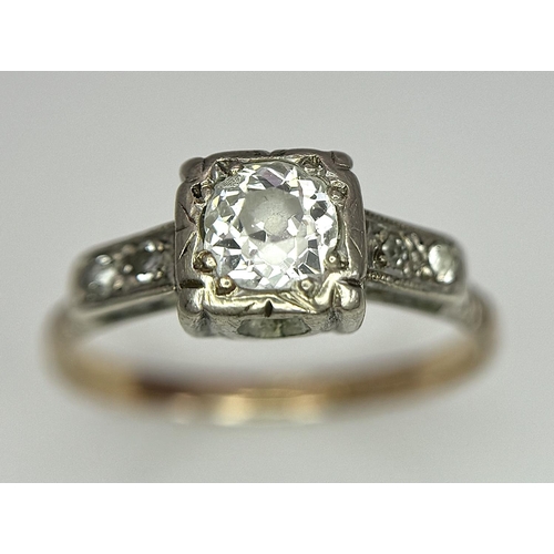 568 - A Vintage 18K Yellow Gold and Platinum Diamond Ring. 0.75ct central diamond with diamond accents. Si... 