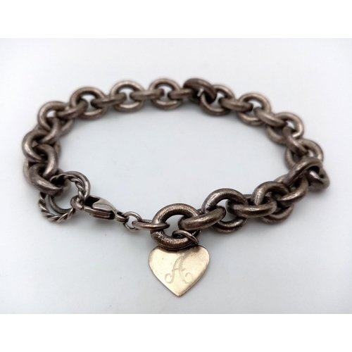 884 - A Vintage Sterling Silver Oval Link Bracelet with Heart Charm. 16cm. 37.5g.