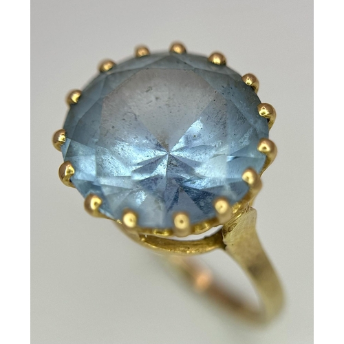 295 - A 9K Yellow Gold Aquamarine Ring. Central round cut 5ct aquamarine. Size L 1/2. 4.2g total weight. 0... 