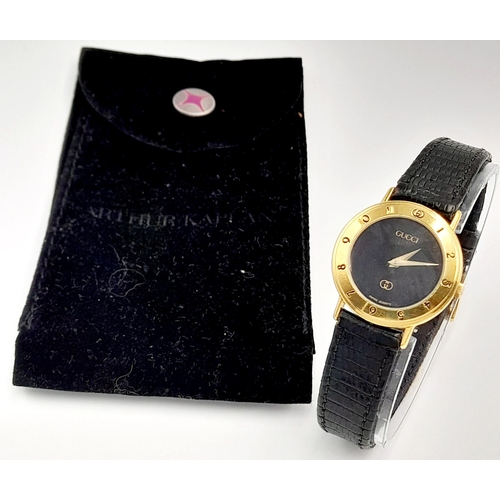 1156 - A Classic Gucci Gold Plated Ladies Quartz Watch. Black leather strap. Gilded case - 26mm. Black dial... 