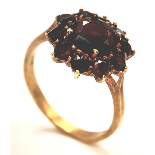 1142 - An 18K Yellow Gold Garnet Floral Cluster Ring. Size P, 3.69g total weight.