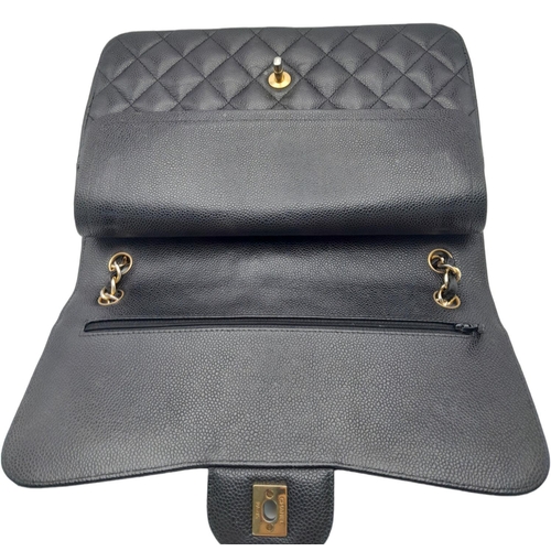 5 - A Chanel Black Classic Double Flap Bag. Quilted leather exterior with gold-toned hardware, chain and... 