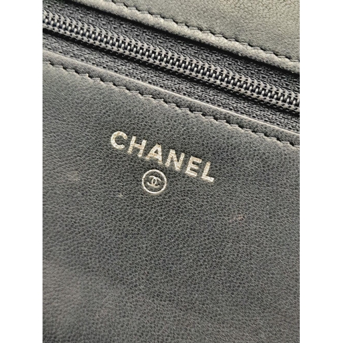 26 - A Chanel Blue Wallet on Chain Crossbody Bag. Quilted leather exterior with silver-toned hardware, ch... 