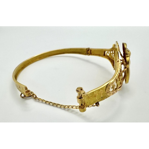 118 - A fine 18 K yellow gold “Egyptian Revival” bangle with a three-dimensional scarab and Tutankhamun’s ... 