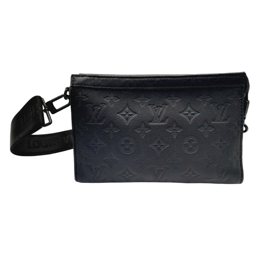 89 - A Louis Vuitton Black Gaston Wearable Wallet. Monogram coated canvas exterior with black-toned hardw... 