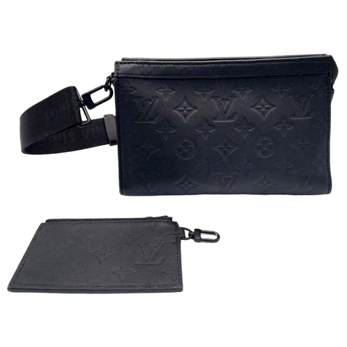 89 - A Louis Vuitton Black Gaston Wearable Wallet. Monogram coated canvas exterior with black-toned hardw... 