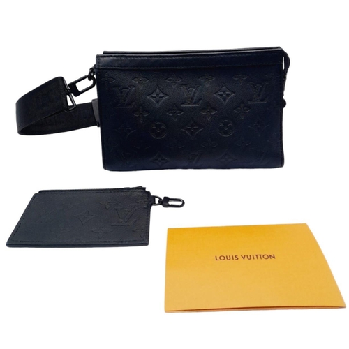 89 - A Louis Vuitton Black Gaston Wearable Wallet. Monogram coated canvas exterior with black-toned hardw... 