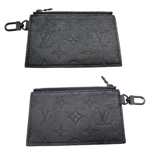 89 - A Louis Vuitton Black Gaston Wearable Wallet. Monogram coated canvas exterior with black-toned hardw... 