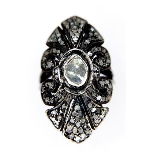 139 - An antique ARTS & CRAFTS sterling silver ring with a shield design adored with a central old cut dia... 